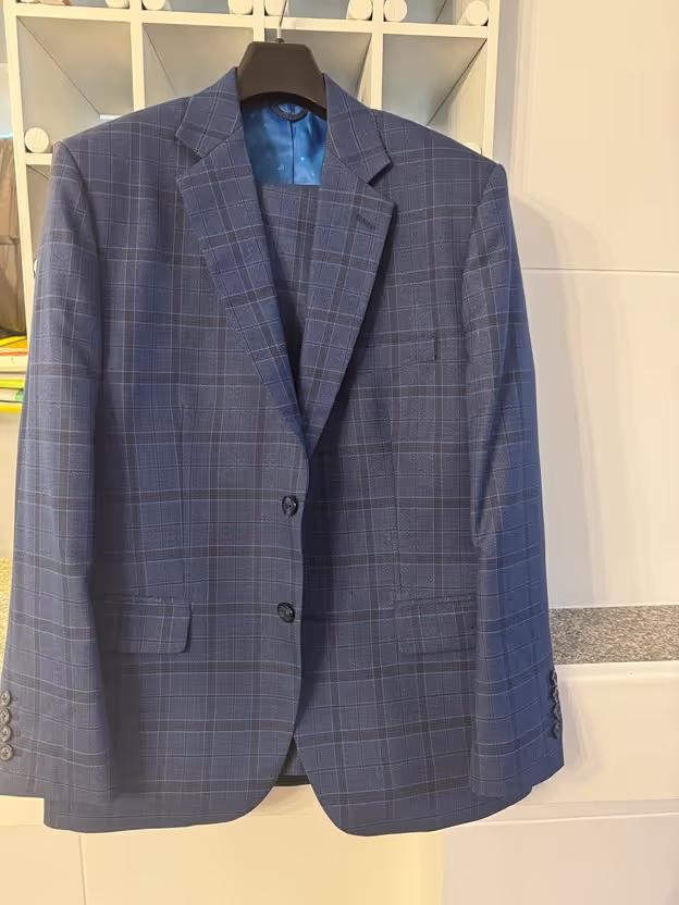 Use Proper Hangers: Invest in sturdy, broad-shouldered hangers designed specifically for suits. This helps maintain the shape of the shoulders and prevents creases.