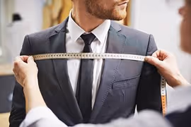 Every suit should be properly tailored. The fit should be perfect around the shoulders, chest, and waist. Encourage clients to visit their tailor for adjustments after the initial fitting.